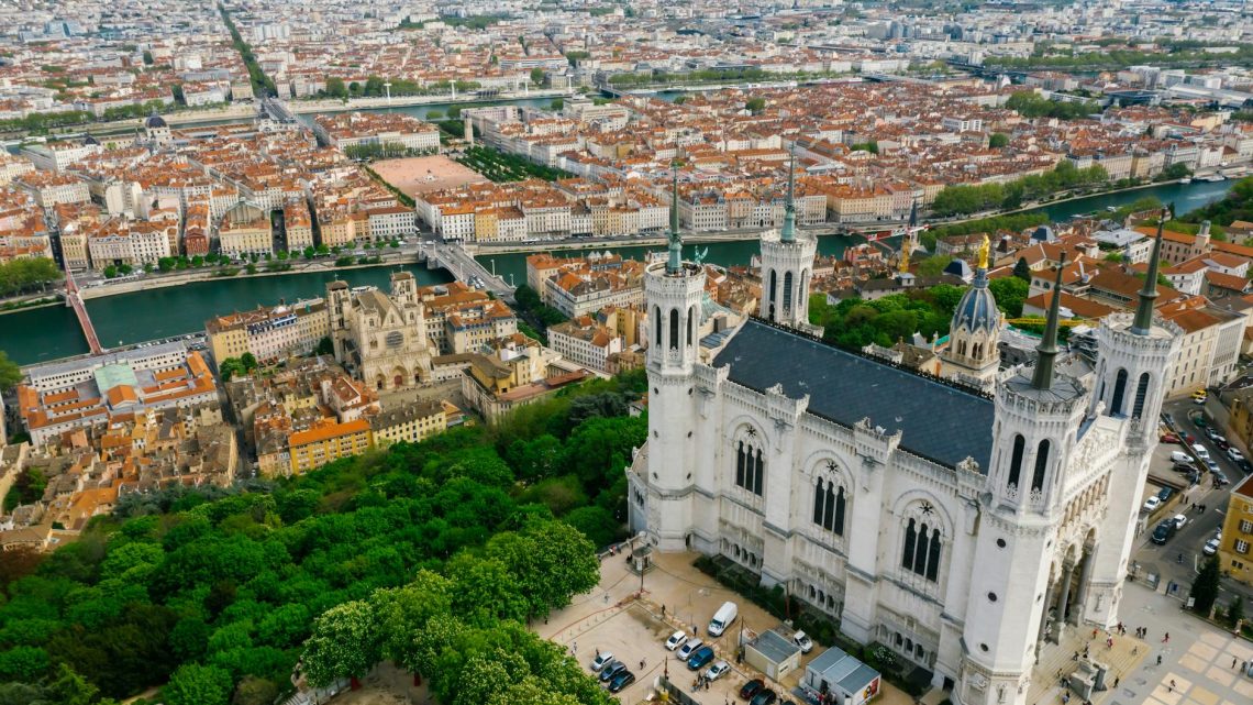 Stunning aerial view of Lyon featuring the Basilica of Notre-Dame de Fourvière and the cityscape.